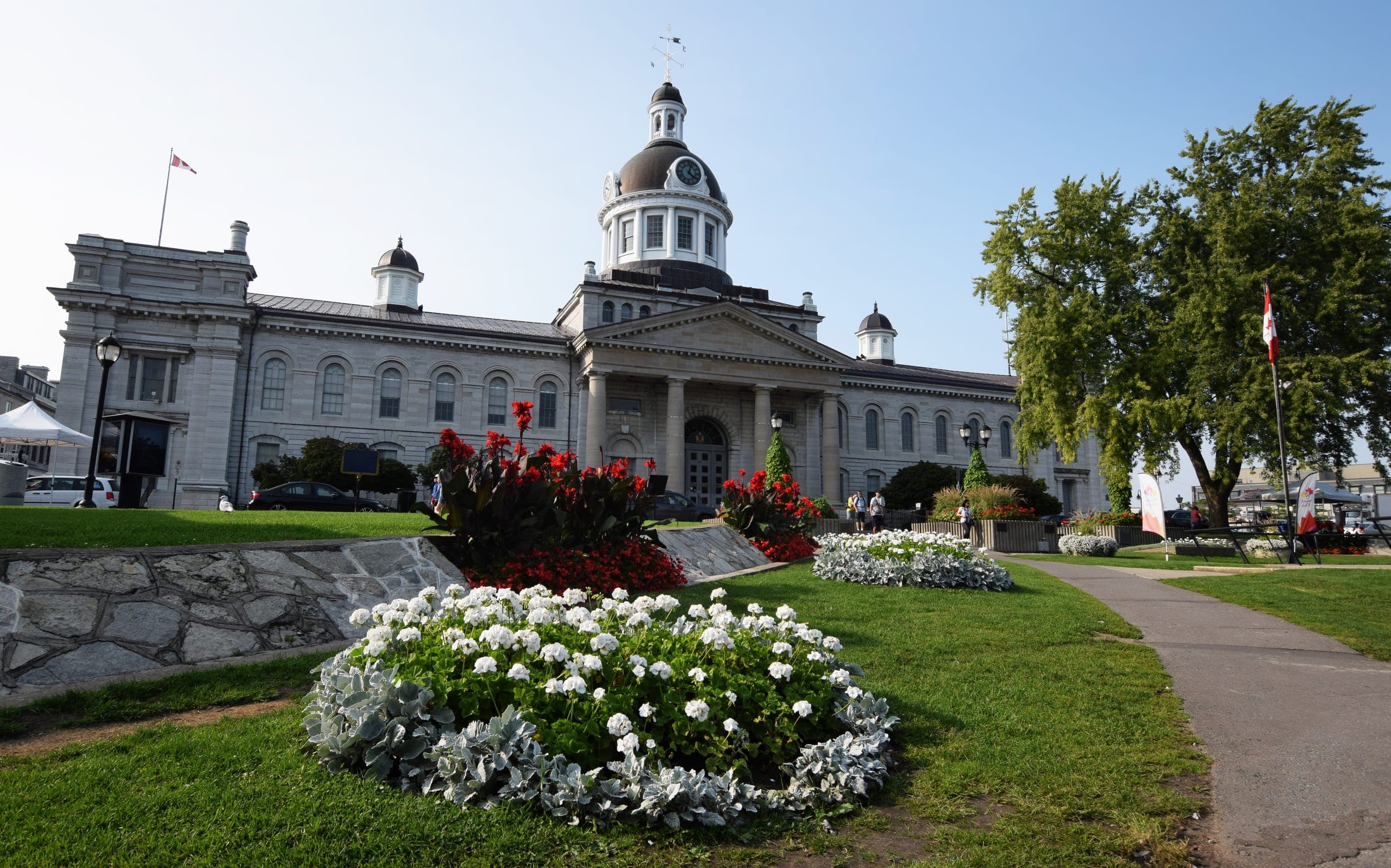 Kingston City Hall seen from Confederation Park, flower beds in front